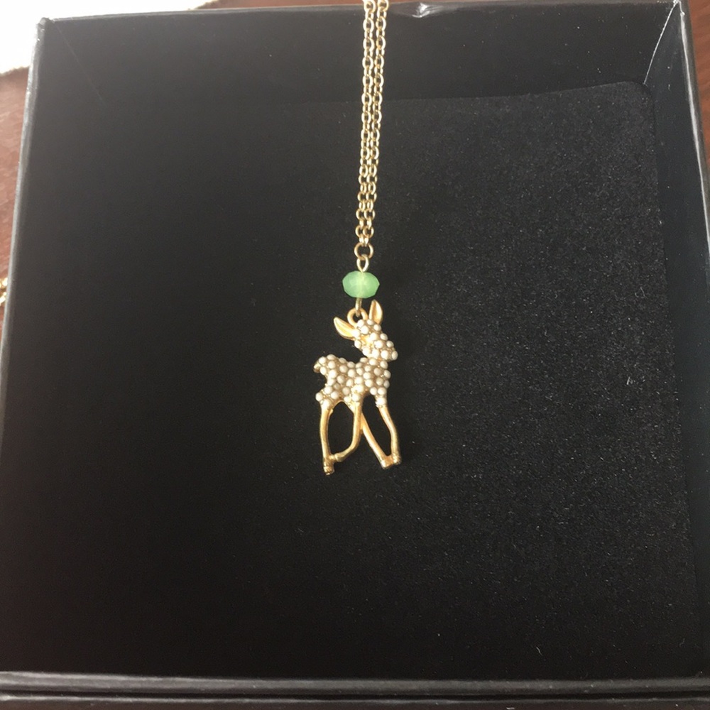 Charming deer necklace with mint green detail.